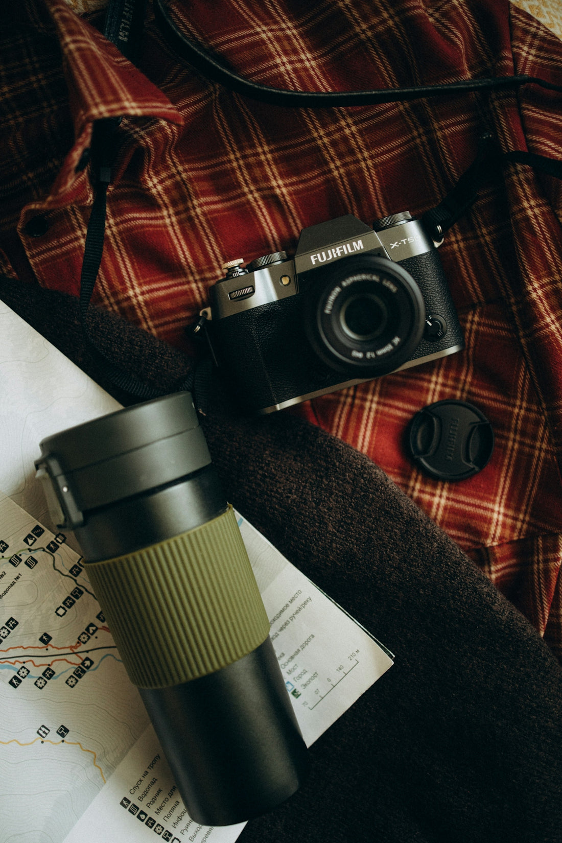 Camera, thermos, and map for travel adventure